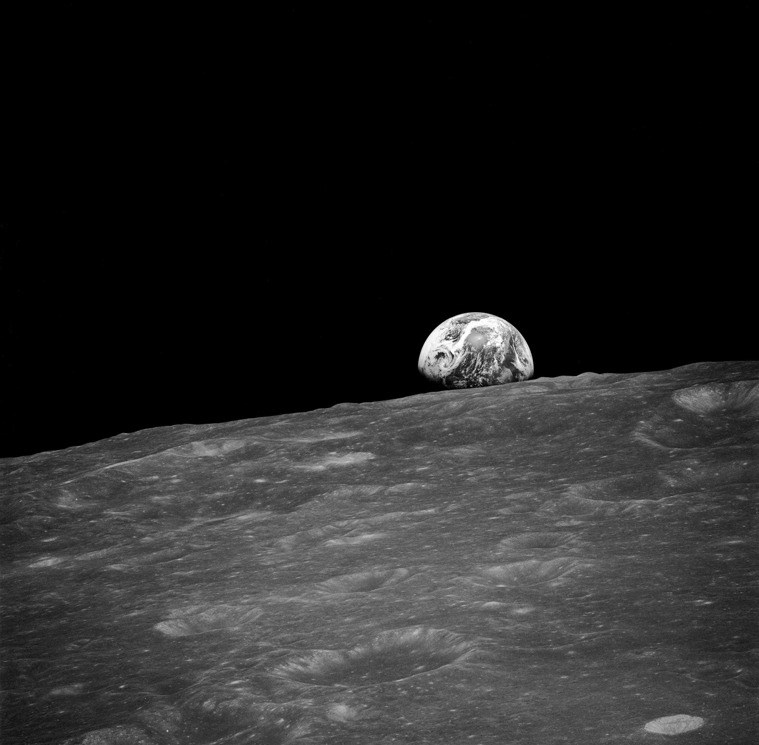The earth rising over the lunar horizon